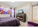 Bedroom with fireplace, TV, and access to hallway at 12854 Boggy Creek Dr, Riverview, FL 33579