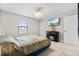 Bedroom with fireplace, TV, and stylish bedding at 12854 Boggy Creek Dr, Riverview, FL 33579