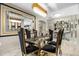 Elegant dining room featuring a glass table, black velvet chairs, and a stunning chandelier at 12854 Boggy Creek Dr, Riverview, FL 33579