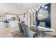 Open concept dining room with kitchen view, glass table, and blue accents at 12854 Boggy Creek Dr, Riverview, FL 33579
