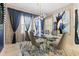 Elegant dining room with glass table and blue velvet chairs at 12854 Boggy Creek Dr, Riverview, FL 33579