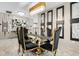 Bright dining room with a glass table and gold-trimmed chairs, showcasing a modern design at 12854 Boggy Creek Dr, Riverview, FL 33579