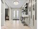 Bright entryway with tile floors and a statement mirror at 12854 Boggy Creek Dr, Riverview, FL 33579