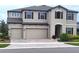 Two-story house with beige walls and brown shutters at 12854 Boggy Creek Dr, Riverview, FL 33579