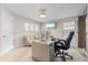 Home office featuring a large desk, comfortable seating, and plenty of natural light at 12854 Boggy Creek Dr, Riverview, FL 33579
