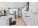 Modern kitchen with white cabinets, quartz countertops, and stainless steel appliances at 12854 Boggy Creek Dr, Riverview, FL 33579