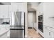 Modern kitchen with white cabinets, quartz countertops, and stainless steel appliances at 12854 Boggy Creek Dr, Riverview, FL 33579