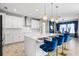 Modern kitchen with white cabinets, quartz countertops, and stainless steel appliances at 12854 Boggy Creek Dr, Riverview, FL 33579
