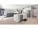 Modern kitchen island with white cabinets and a farmhouse sink at 12854 Boggy Creek Dr, Riverview, FL 33579