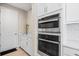 Modern kitchen with stainless steel appliances and white cabinetry at 12854 Boggy Creek Dr, Riverview, FL 33579