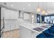 Modern kitchen with white cabinets, quartz countertops, and stainless steel appliances at 12854 Boggy Creek Dr, Riverview, FL 33579