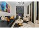 Living room with black velvet sofa, gold accents, and electric fireplace at 12854 Boggy Creek Dr, Riverview, FL 33579