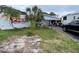 House front yard with a moving container and car at 1355 Devonshire N Dr, St Petersburg, FL 33710