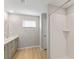 Bathroom with double vanity, light wood floors and a shower at 14729 Summer Branch Dr, Lithia, FL 33547