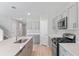 Modern kitchen with gray cabinets, quartz countertops, and stainless steel appliances at 14729 Summer Branch Dr, Lithia, FL 33547