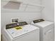 Bright laundry room, complete with Whirlpool washer and dryer, and ample shelving at 14729 Summer Branch Dr, Lithia, FL 33547