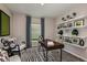 Bright home office features built-in shelving and comfortable seating at 14733 Summer Branch Dr, Lithia, FL 33547