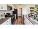 Modern kitchen with white cabinets, stainless steel appliances, and a large island at 14733 Summer Branch Dr, Lithia, FL 33547