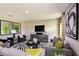 Open living area with gray sofas, a black coffee table, and large artwork at 14733 Summer Branch Dr, Lithia, FL 33547