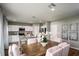 Dining room with wooden table and white chairs, adjacent to kitchen at 14741 Summer Branch Dr, Lithia, FL 33547