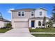 Two-story house with a blue door and attached garage at 14741 Summer Branch Dr, Lithia, FL 33547