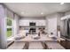 Modern kitchen with white cabinets, island, and stainless steel appliances at 14741 Summer Branch Dr, Lithia, FL 33547
