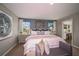Spacious main bedroom with a king-size bed and access to the bathroom at 14741 Summer Branch Dr, Lithia, FL 33547