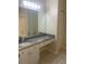 Bathroom with granite countertops, a large mirror, and a white vanity at 18001 Richmond Place Dr # 125, Tampa, FL 33647