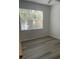 Spacious bedroom with wood-look flooring and large window at 18001 Richmond Place Dr # 125, Tampa, FL 33647