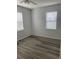 Bright bedroom featuring wood-look flooring and window blinds at 18001 Richmond Place Dr # 125, Tampa, FL 33647