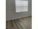 Well-lit bedroom with wood-look flooring and window blinds at 18001 Richmond Place Dr # 125, Tampa, FL 33647