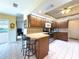 Kitchen boasts wood cabinets, granite counters & stainless steel appliances at 1809 Citrus Orchard Way, Valrico, FL 33594