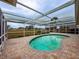 Relaxing kidney-shaped pool with covered patio at 1809 Citrus Orchard Way, Valrico, FL 33594