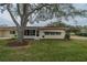 Backyard view of home with screened porch at 2035 Hampstead Cir # 275, Sun City Center, FL 33573