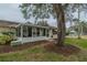 Backyard with screened porch and large shade tree at 2035 Hampstead Cir # 275, Sun City Center, FL 33573