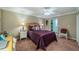 Cozy bedroom with a purple comforter and ample closet space at 2035 Hampstead Cir # 275, Sun City Center, FL 33573