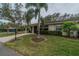 House exterior showcasing landscaping and driveway at 2035 Hampstead Cir # 275, Sun City Center, FL 33573