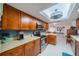 Modern kitchen with wood cabinets, tile backsplash and island at 2035 Hampstead Cir # 275, Sun City Center, FL 33573