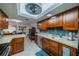 Modern kitchen with wood cabinets and stainless steel appliances at 2035 Hampstead Cir # 275, Sun City Center, FL 33573
