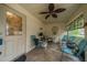Cozy screened porch with seating and ceiling fan at 2035 Hampstead Cir # 275, Sun City Center, FL 33573
