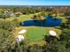 Aerial view showing a golf course green, sand traps, and pond at 2781 Westchester Dr S, Clearwater, FL 33761