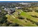 Aerial view of golf course, clubhouse, and tennis courts at 2781 Westchester Dr S, Clearwater, FL 33761