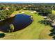 Aerial view of a golf course with pond and lush greens at 2781 Westchester Dr S, Clearwater, FL 33761