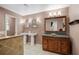 Bathroom with double vanity, large mirror and soaking tub at 2781 Westchester Dr S, Clearwater, FL 33761