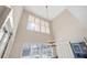 High-ceiling dining area with chandelier and large windows at 2781 Westchester Dr S, Clearwater, FL 33761