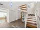 Bright entryway with tiled floors and a wooden staircase at 2781 Westchester Dr S, Clearwater, FL 33761