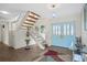 Bright entryway with tiled floors and a wooden staircase at 2781 Westchester Dr S, Clearwater, FL 33761