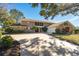 Two-story house with stone accents and a large driveway at 2781 Westchester Dr S, Clearwater, FL 33761