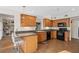 Eat-in kitchen with wood cabinets, granite counters & black appliances at 2781 Westchester Dr S, Clearwater, FL 33761
