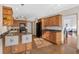 Kitchen with wood cabinets, granite countertops, and bar seating at 2781 Westchester Dr S, Clearwater, FL 33761